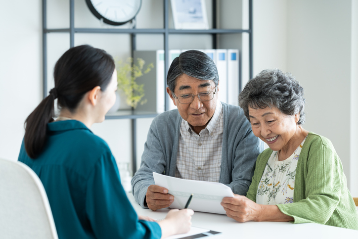 Older couple at home with a folder of investment documents