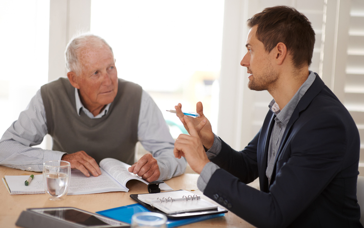 Man reviewing property documents with an advisor